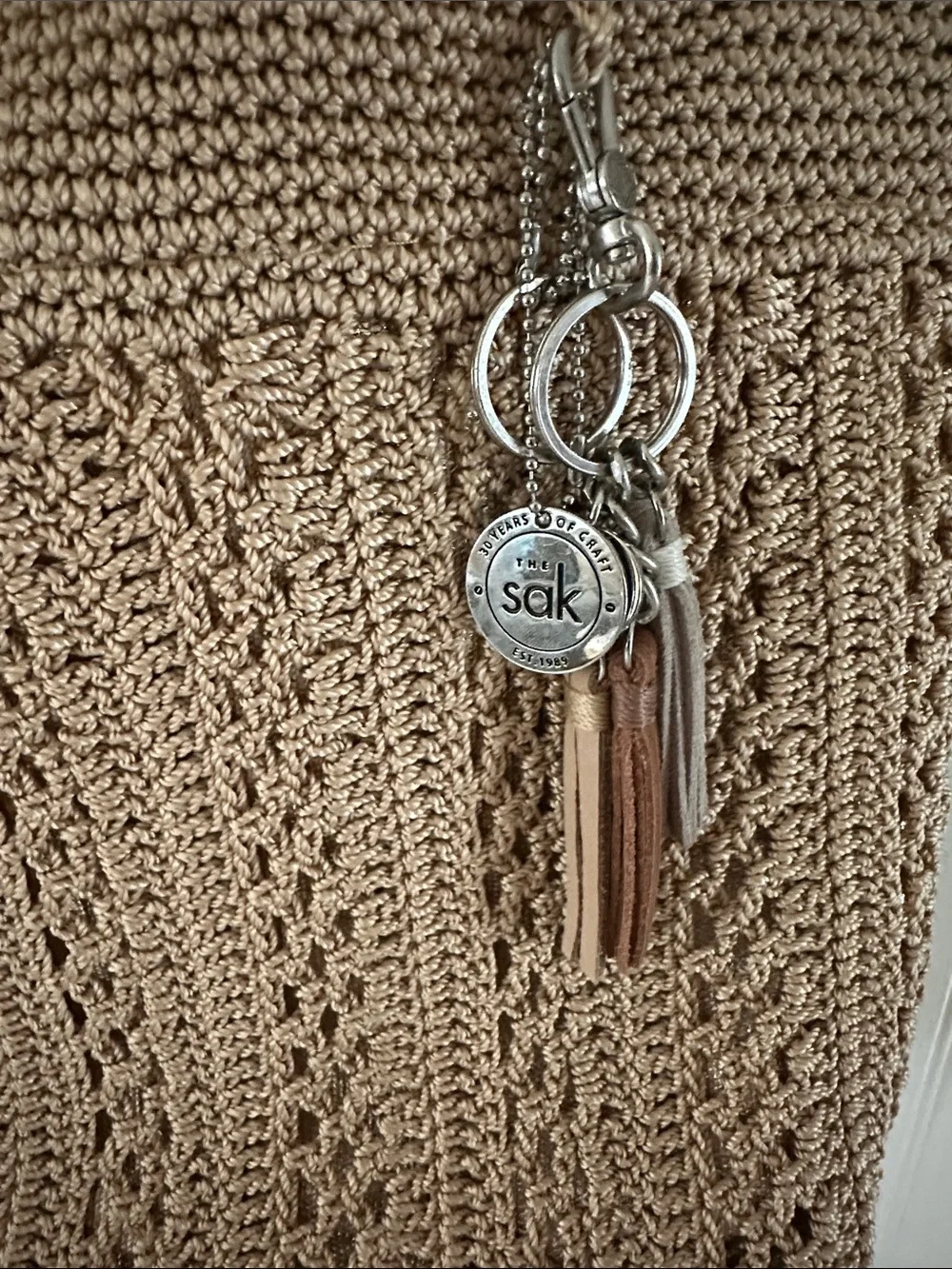 The Sak Tan Crochet Gold Underlay Tote Bag with Tassel Charm Like New